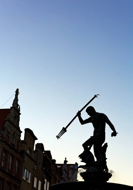 silhouette of a man in a black suit with a sword on a background of blue sky - Фото, зображення