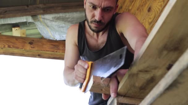The carpenter saws with a metal hacksaw and carefully looks at the part. - Filmati, video