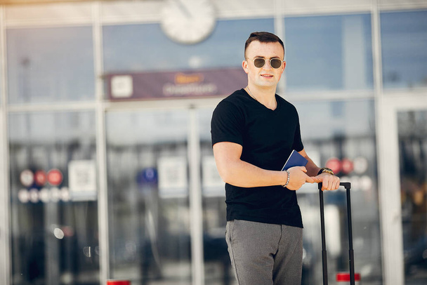 Handsome man standing in a airport - Foto, Imagen