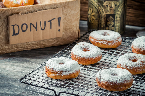 Fresh donuts with powder sugar on cooling rack - Valokuva, kuva