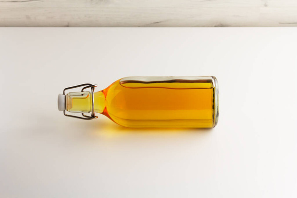 Apple cider, vinegar, juice in a glass bottle on a light background - Photo, Image