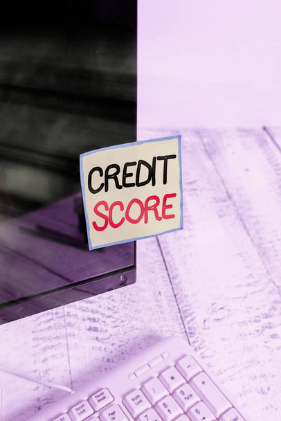 Handwriting text Credit Score. Concept meaning numerical expression that indicates an individual s is creditworthiness Notation paper taped to black computer monitor screen near white keyboard. - Photo, Image
