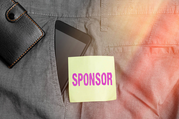 Word writing text Sponsor. Business concept for provide funds for special events in exchange for advertising Smartphone device inside trousers front pocket with wallet and note paper. - Photo, Image
