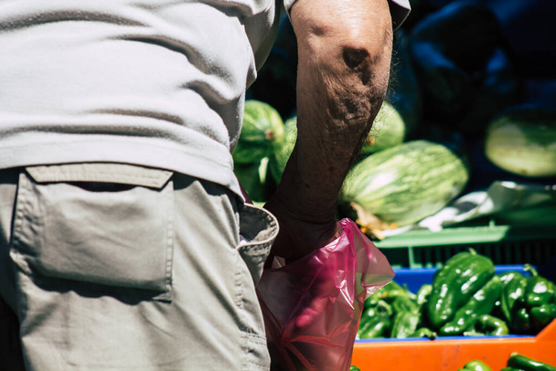 Limassol Cyprus June 13, 2020 Closeup of the hand of unidentified people choosing fruit and veg at the Limassol market in the morning in Cyprus - 写真・画像