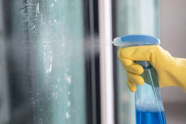 Employees are using spray cleaning glass. - Photo, Image