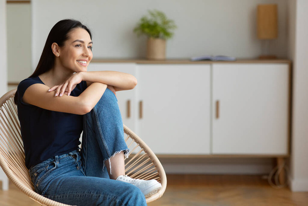 Happy Woman Relaxing Sitting In Cozy Modern Chair At Home - Photo, Image
