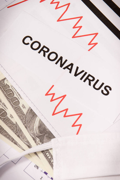 Inscription coronavirus, currencies dollar and downward graphs representing financial crisis caused by Covid-19. Risk of global recession around world - Фото, зображення