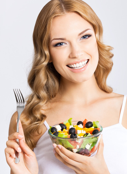 Woman with vegetarian salad, over gray - Zdjęcie, obraz
