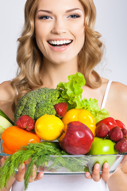 Young woman with vegetarian food, over gray - Фото, зображення