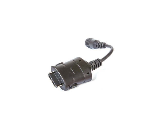 Malý elektrický adaptér pro nabíjení malých elektrických zařízení, detailní záběr na bílé izolované - Fotografie, Obrázek