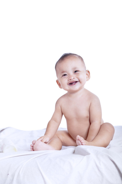 Expressive baby laughing in the bedroom - Fotó, kép