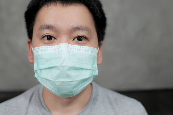 Man wearing hygienic mask to prevent infection, airborne respiratory illness such as flu, 2019-nCoV.Protection against contagious disease, coronavirus. - Photo, Image