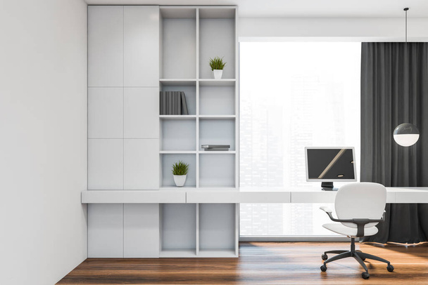Front view of stylish minimalistic home office with white walls, dark wooden floor, comfortable white bookcase and computer table standing near window with blurry cityscape. 3d rendering - Foto, afbeelding