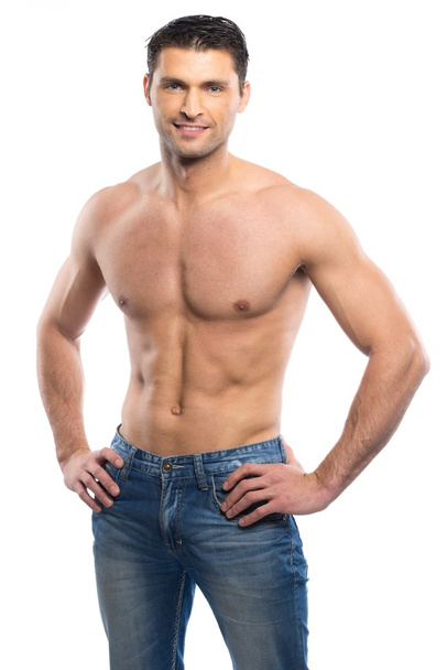 schöner junger Mann in blauen Jeans mit nacktem Oberkörper - Foto, Bild