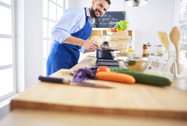 Man preparing delicious and healthy food in the home kitchen - Fotografie, Obrázek