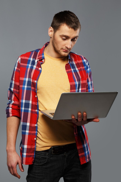 Stylish young man with a laptop - Photo, image