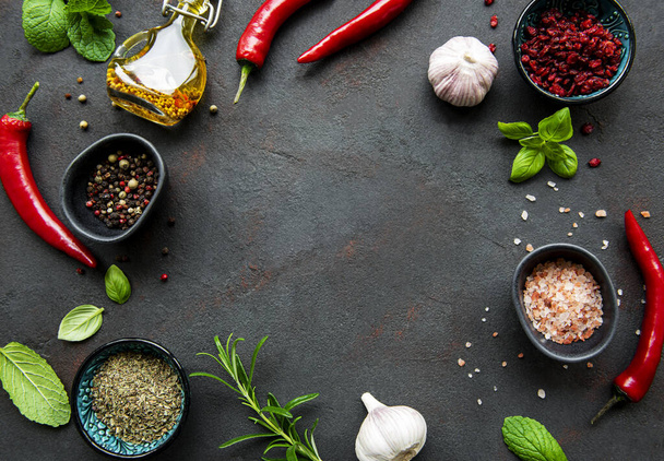 Frame of spices, herbs and vegetables on a dark stone background. Top view, flat lay. - Foto, Bild