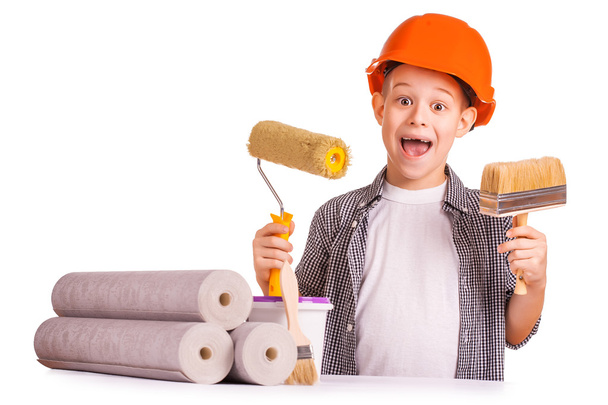 Kid with a rolls of wallpaper and brush. isolated - Photo, image
