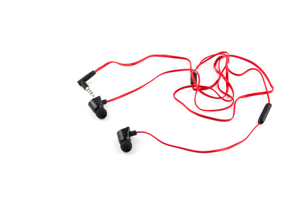 Red earphones isolated on white background, selcetive focus. - 写真・画像