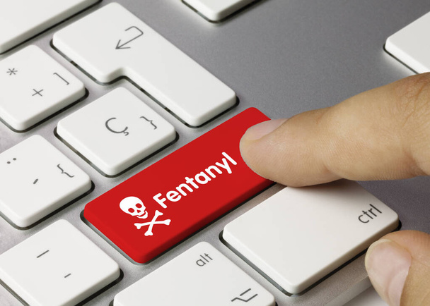 Fentanyl Written on Red Key of Metallic Keyboard. Finger pressing key. - Photo, Image