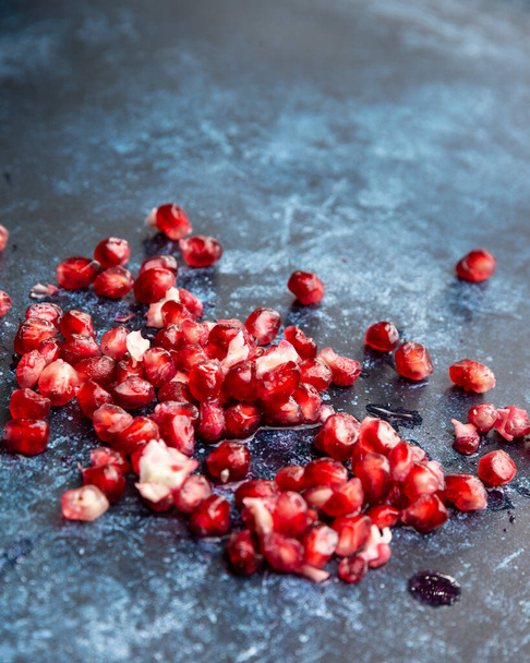 Beautiful food portrait of pulled Pomegranate and seeds with vintage texture background - Foto, imagen