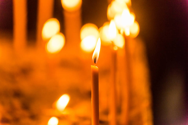 Burning candles in St. Stephen's Cathedral, the mother church of the Roman Catholic Archdiocese of Vienna and the seat of the Archbishop of Vienna, Austria - Photo, Image