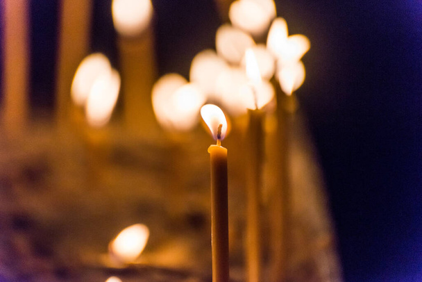 Burning candles in St. Stephen's Cathedral, the mother church of the Roman Catholic Archdiocese of Vienna and the seat of the Archbishop of Vienna, Austria - Photo, Image