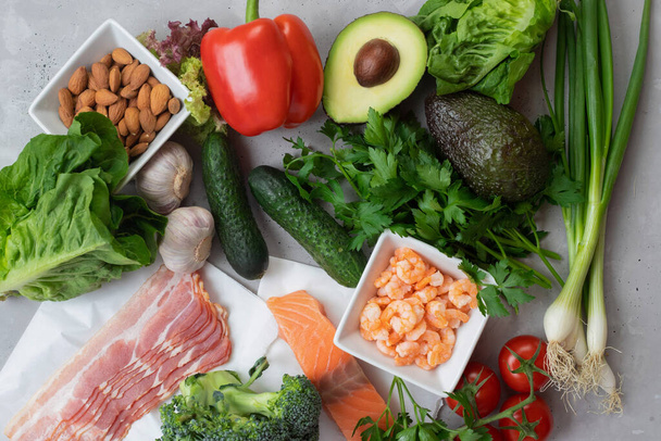 Keto diet concept. A set of keto nutrition products. Fresh vegetables, seafood, bacon and nuts - Photo, Image