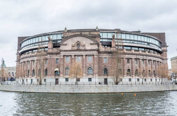 Riksdag (Parliament) Building at the bank of canal gainst cloudy sky in Stockholm, Sweden.  - Foto, Bild