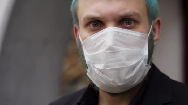 man with dyed hair and a beard in a protective mask - Felvétel, videó