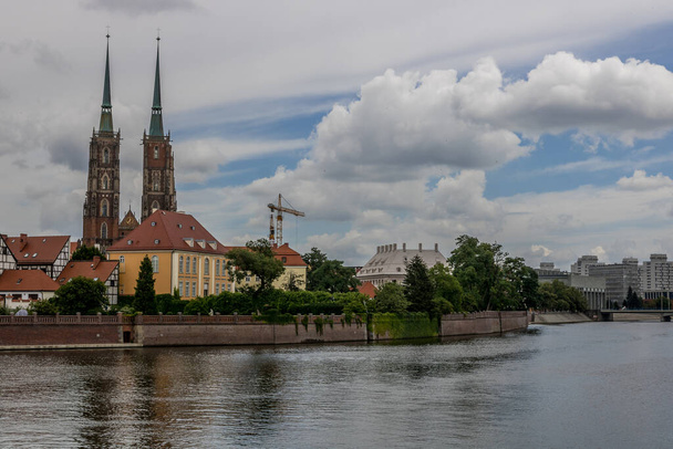 Річка в місті Вроцлав з великим покриттям хмар і вигином з лівого боку. - Фото, зображення