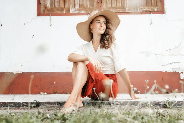 Beautiful stylish elegant fashionable young brunette woman in a hat, looking at the camera, beauty and fashion - Fotó, kép