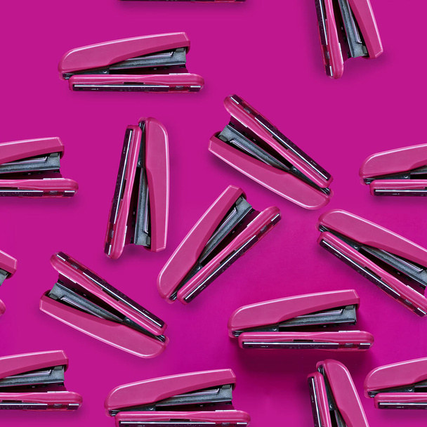 bright pink stapler on a bright background pattern - Fotoğraf, Görsel