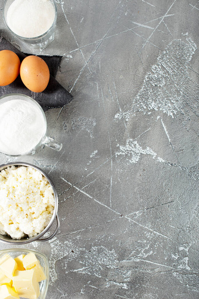 Fresh ingredients for baking, cottage cheese milk sugar eggs on a table - Foto, Imagem