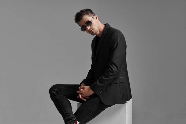 Portrait of young  man in sunglasses on dark background. Studio shot.  - Fotoğraf, Görsel