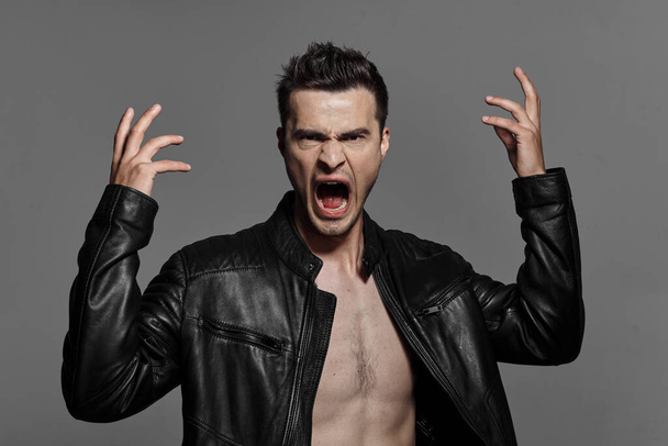 portrait of young angry   handsome man in leather jacket. Studio shot. Fashion photography   - Fotoğraf, Görsel