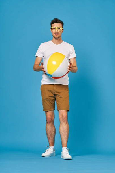 Young man playing with ball in studio  - Photo, Image