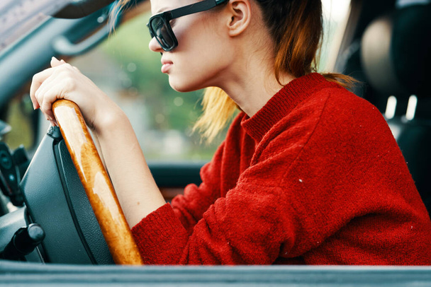 Young beautiful  woman in sunglusses driving  the car - Foto, afbeelding