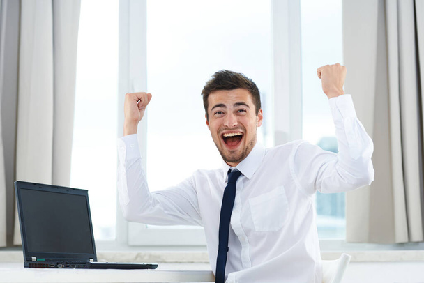 young handsome businessman with laptop computer celebrating  - Photo, Image