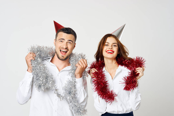 portrait of young beautiful couple celebrating new year in party hats - Fotoğraf, Görsel