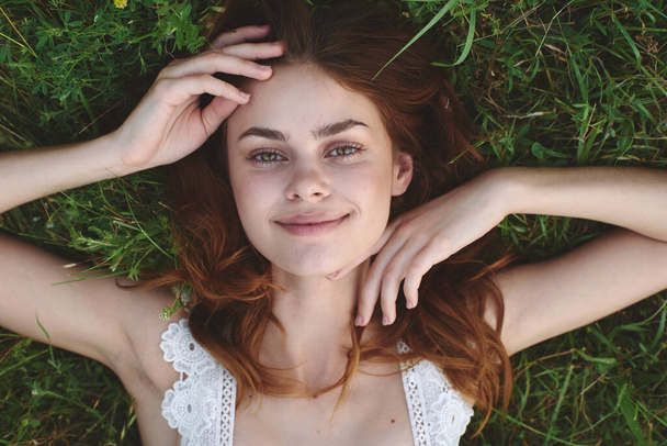 young beautiful woman lying on grass - Фото, изображение