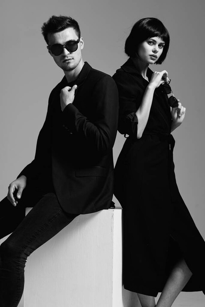 Young beautiful couple posing in studio. Black and white - Photo, Image