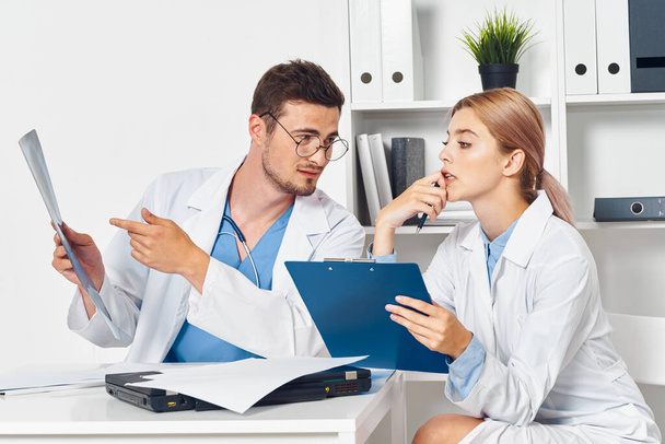 Young doctors working in  hospital office looking at x-ray - Фото, изображение