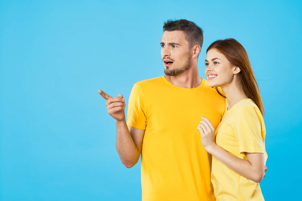 Young  couple  in studio on isolated background pointing with fingers  - Photo, Image