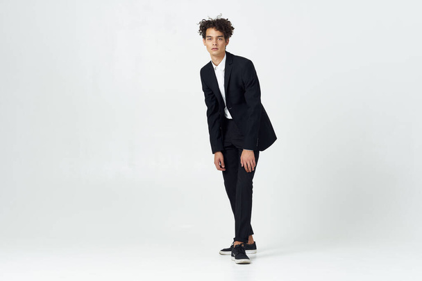        young handsome businessman with curly hair   posing                          - Valokuva, kuva