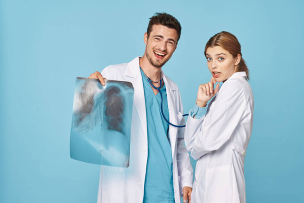 Studio shot. Young doctor and nurse on isolated background - Foto, imagen