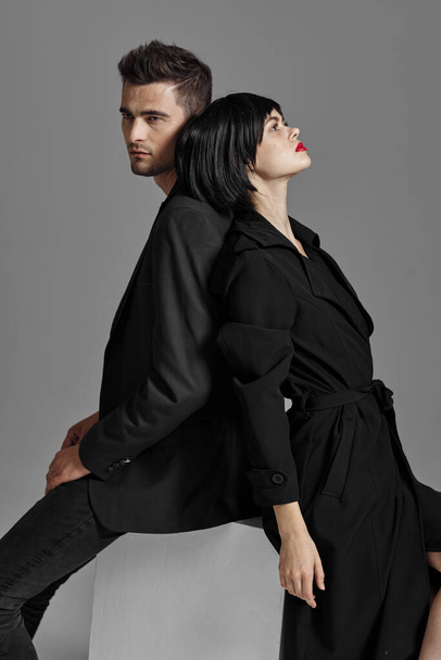 Young beautiful couple in black posing in studio - Fotografie, Obrázek