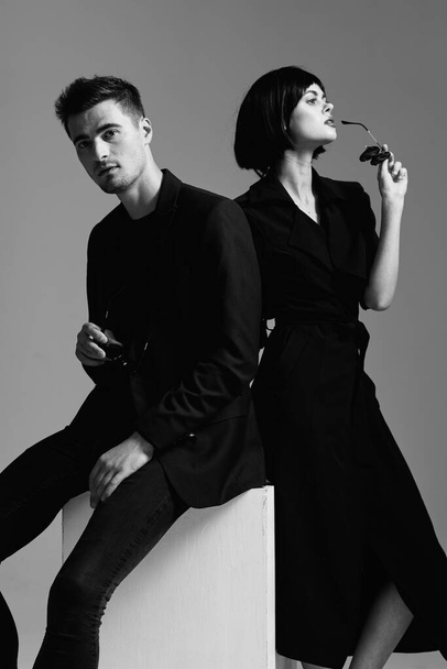 Young beautiful couple posing in studio. Black and white - Fotó, kép