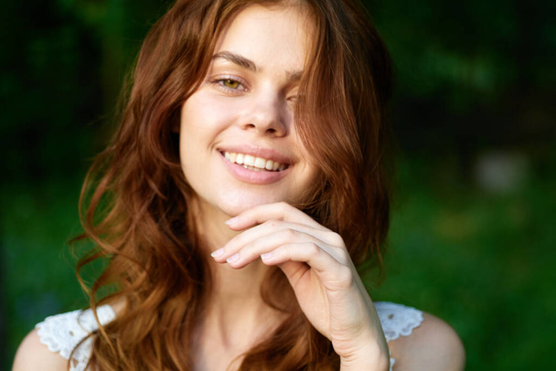 Young beautiful woman posing in summer garden  - Fotó, kép