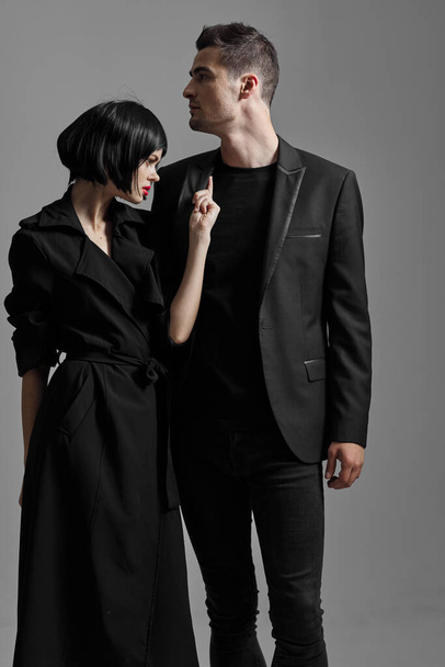 Young beautiful couple in black posing in studio - Valokuva, kuva